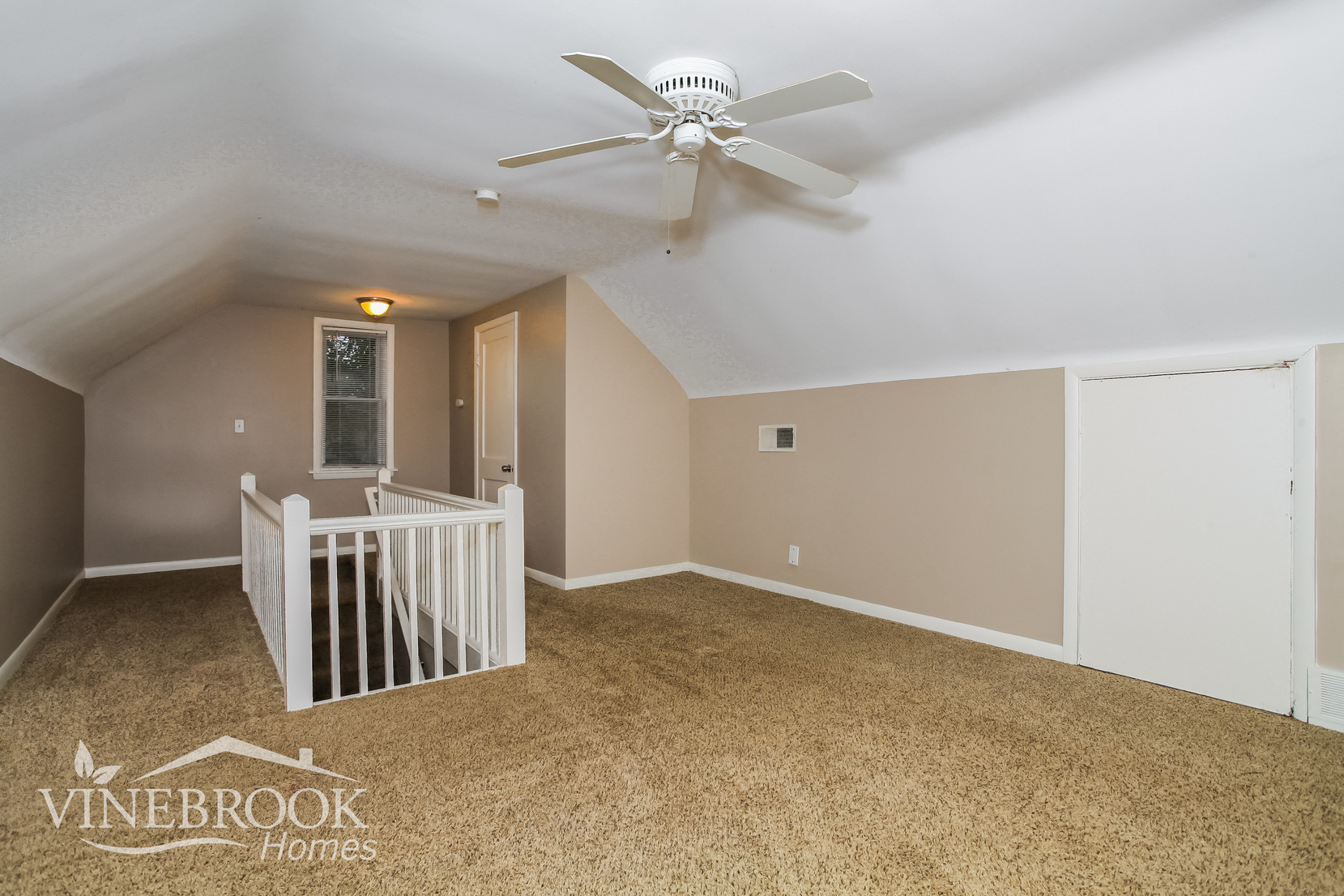 a nursery with a white crib and a ceiling fan