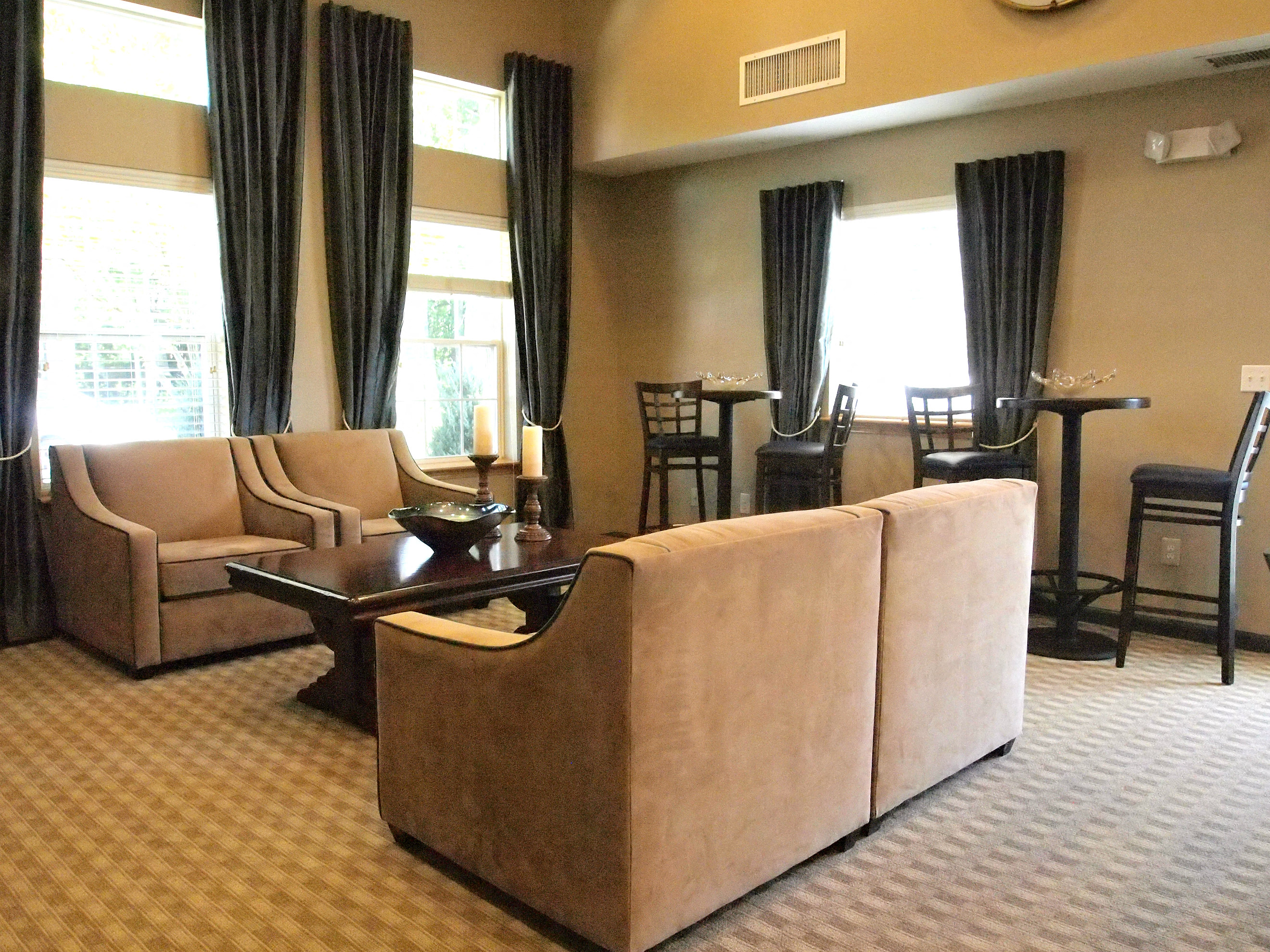 a living room with couches and chairs and a table