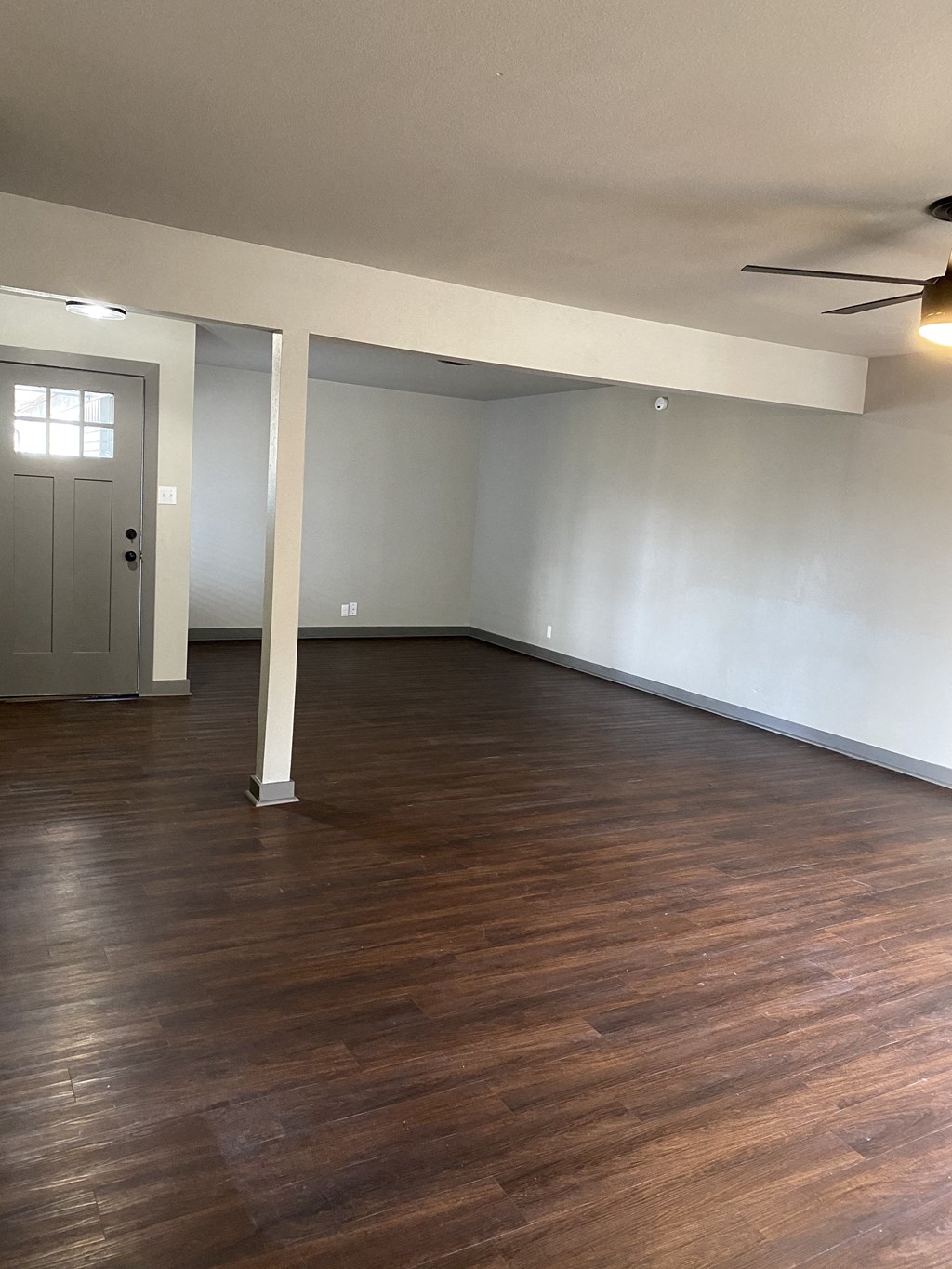 A room with wooden floors and white walls.