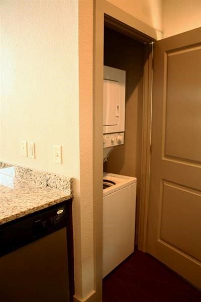 a kitchen with a sink and a stove and a door