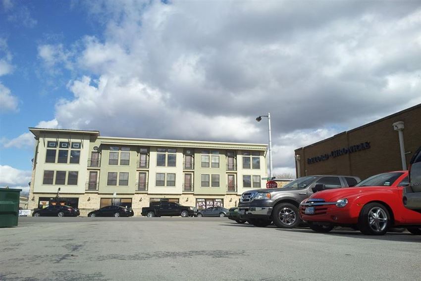 a parking lot with cars parked in front of a building