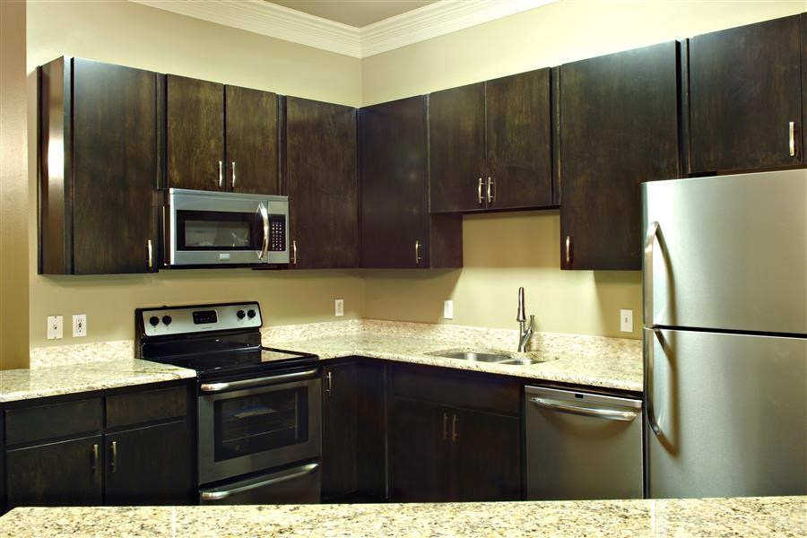 a kitchen with stainless steel appliances and granite counter tops