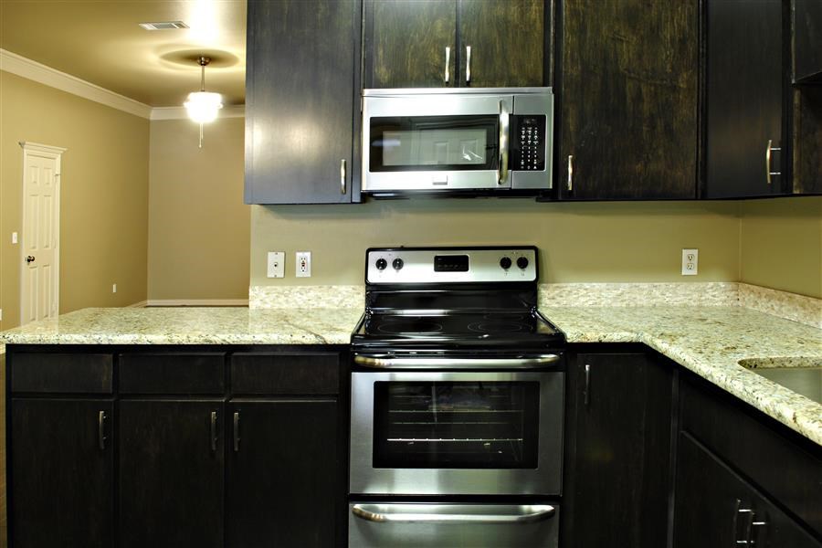 a kitchen with a stove and a microwave