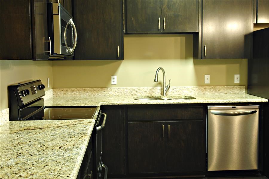 a kitchen with granite counter tops and a sink