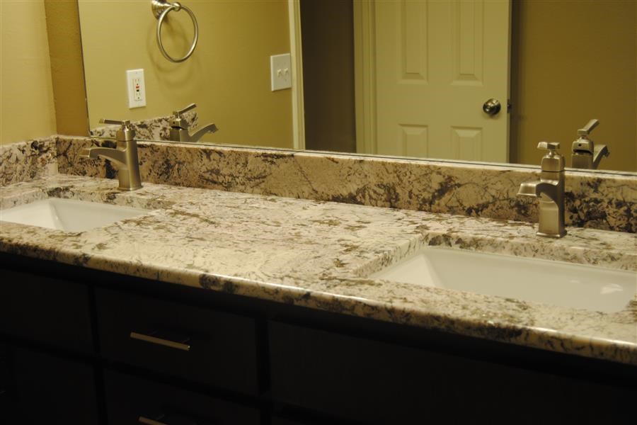 a bathroom with two sinks and a mirror