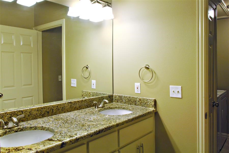 a bathroom with two sinks and a large mirror