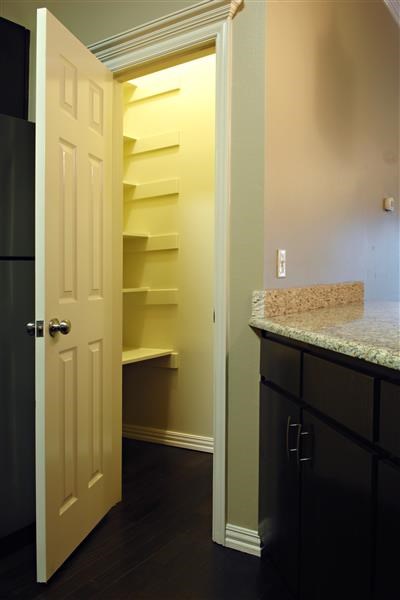 a kitchen with a closet and a white door
