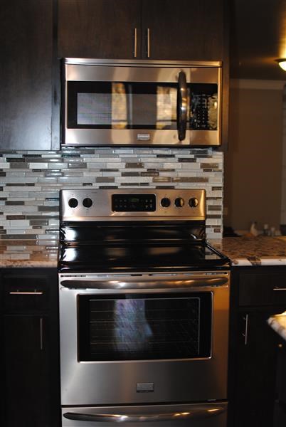 a stainless steel stove and microwave in a kitchen