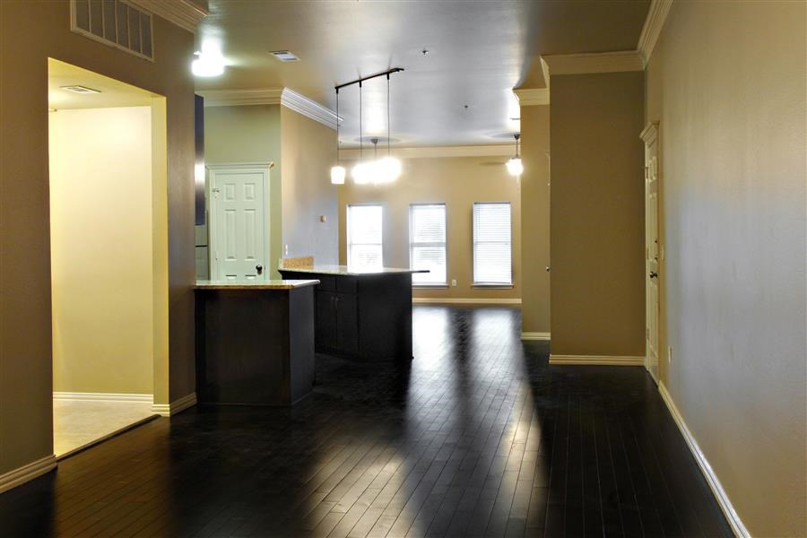 a empty room with a kitchen and a door