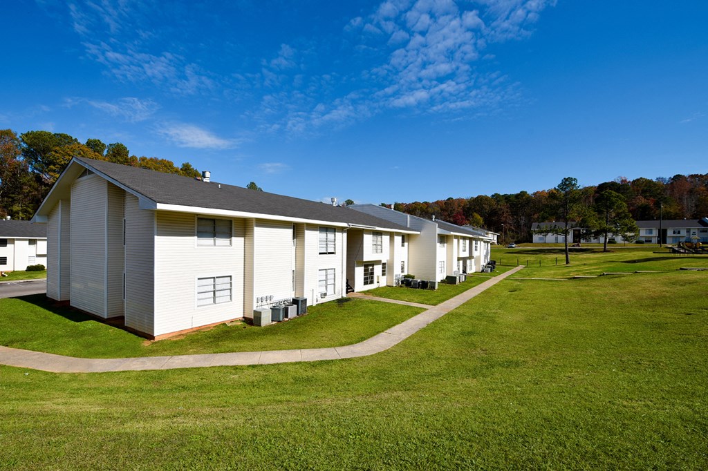 A row of white houses with a blue sky above.