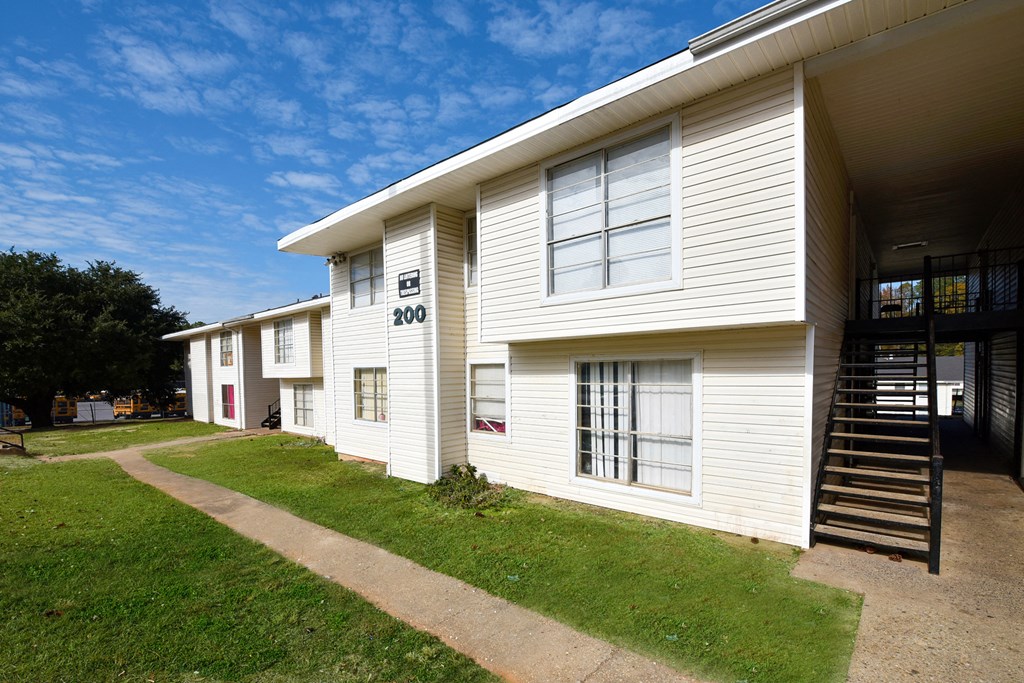 Apartment building number 200 with a green lawn in front.