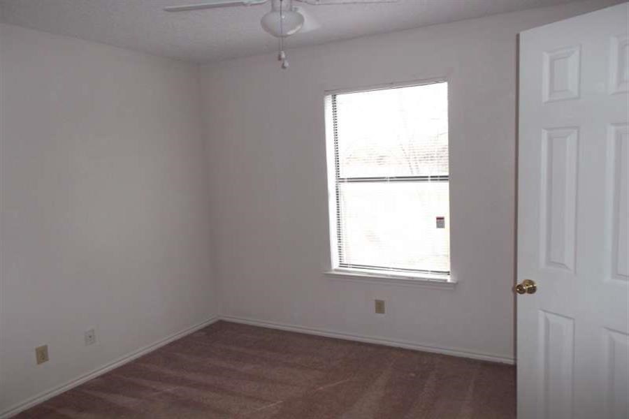 an empty room with a window and a door