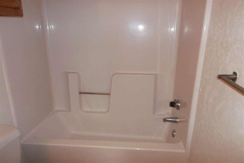 a white bathroom with a shower and a toilet