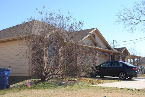 A house with a car parked in front.
