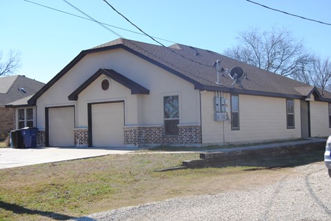 the front of a house with garage doors