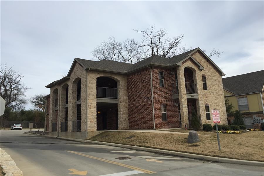 a brick building on the corner of a street