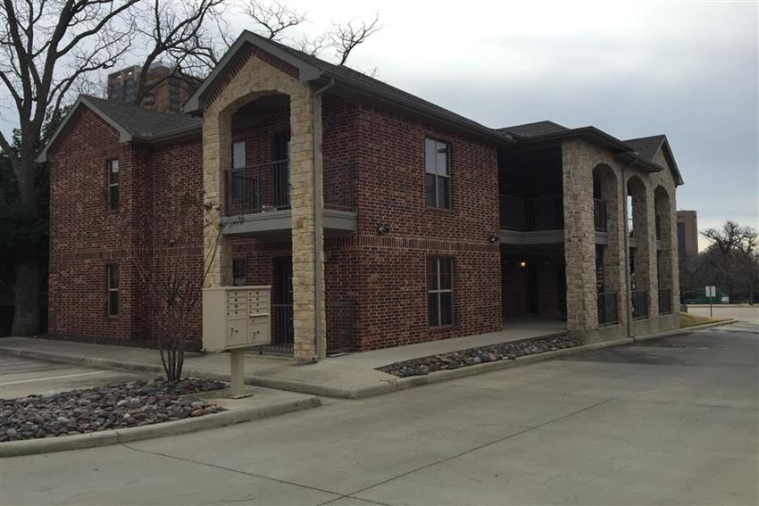 a large brick building with a parking lot