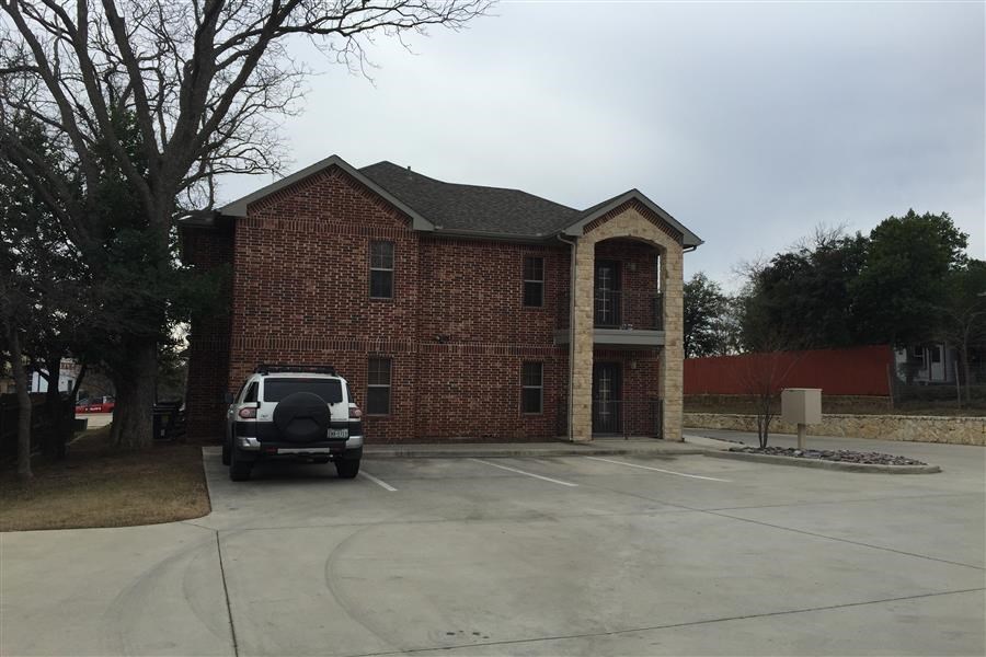 a car parked in a parking lot in front of a house