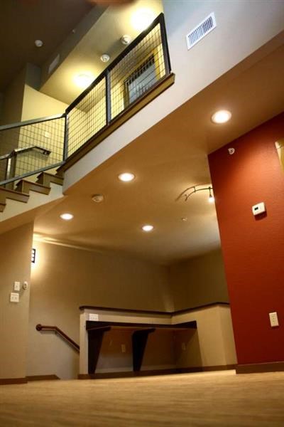 a lobby with a staircase and a table