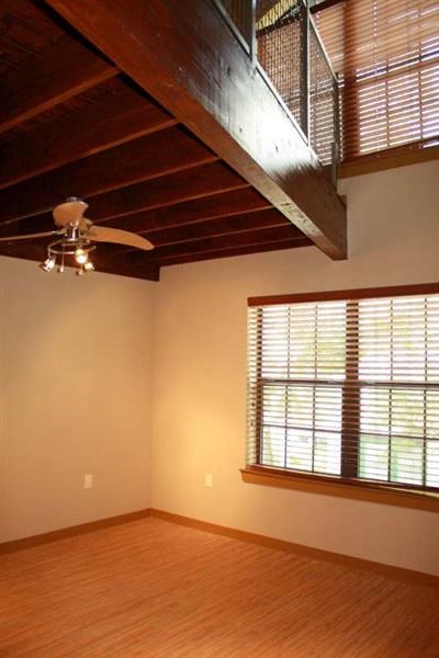 a living room with a ceiling fan and a window