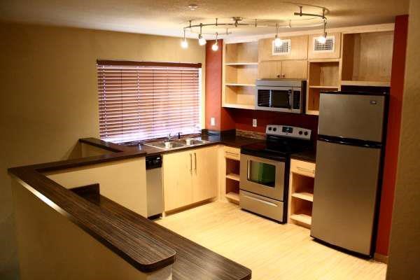 a kitchen with stainless steel appliances and wooden cabinets