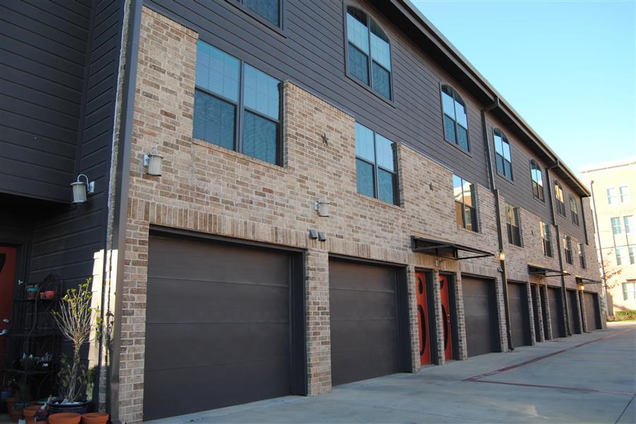 a brick building with three garage doors
