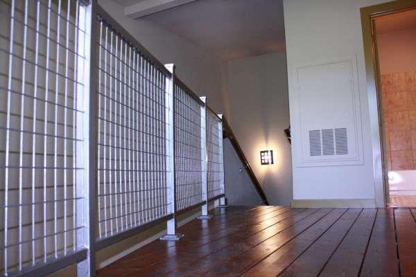 a living room with a wooden floor and a staircase