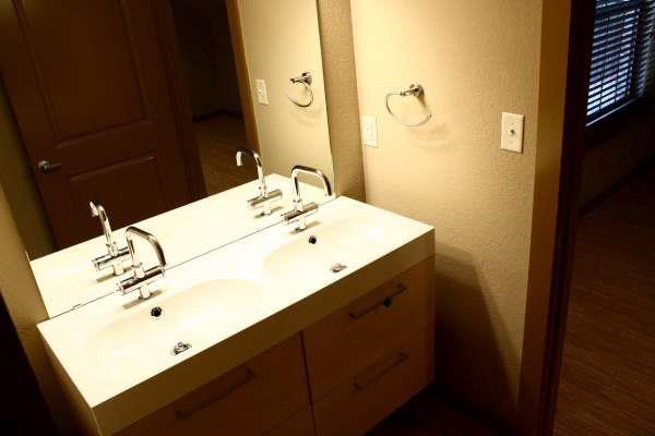 a bathroom with a white sink and a mirror