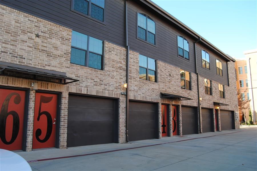 a brick building with black garage doors