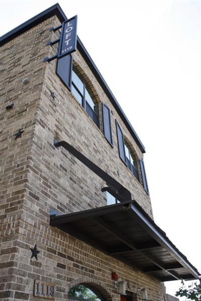 a tall brick building with windows on top of it