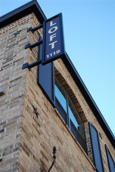 a sign on the side of a brick building