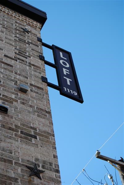 a sign on the side of a brick building
