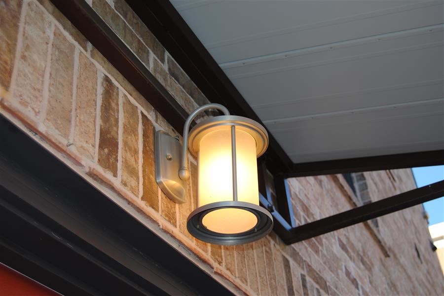 a light on the side of a brick building