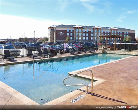 A pool with a slide in front of a building.