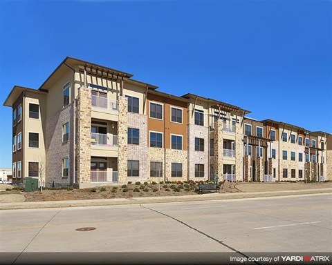 A row of modern apartment buildings with balconies and multiple windows.