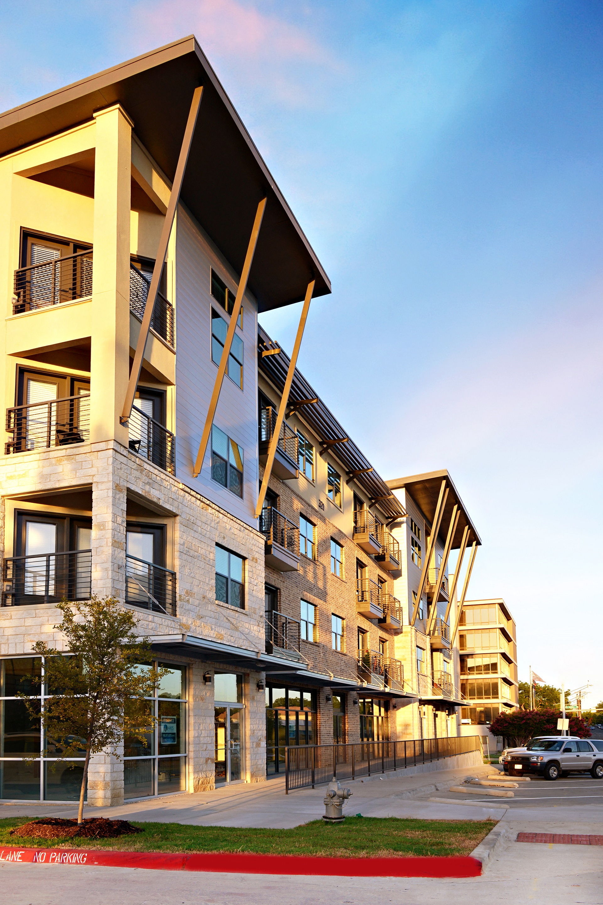 a view of the exterior of a building at sunset