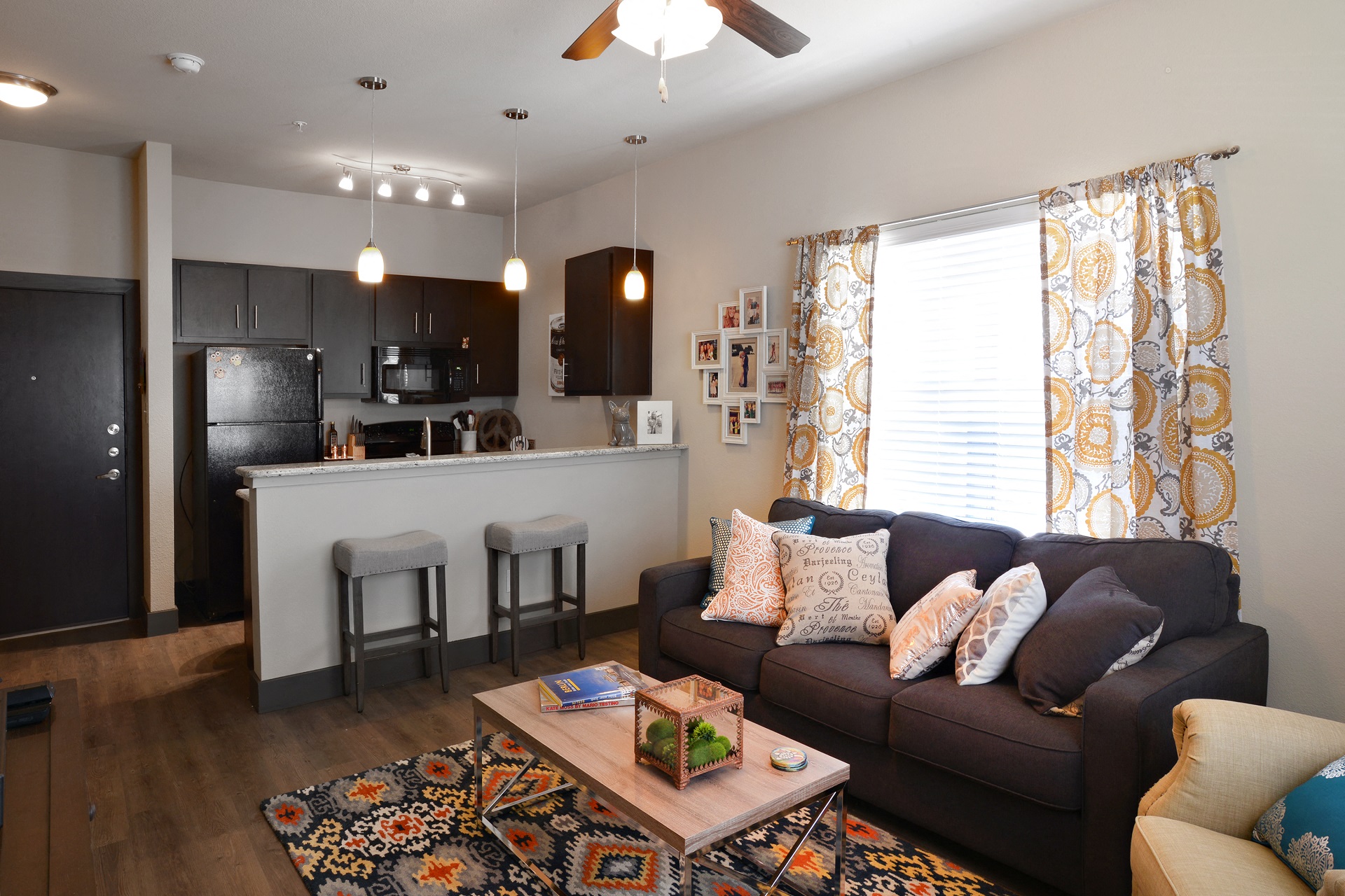 a living room and kitchen with a couch and a coffee table