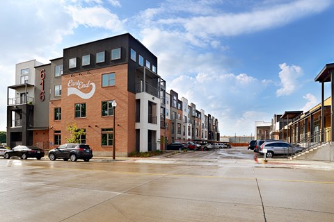a city street with cars parked in front of buildings