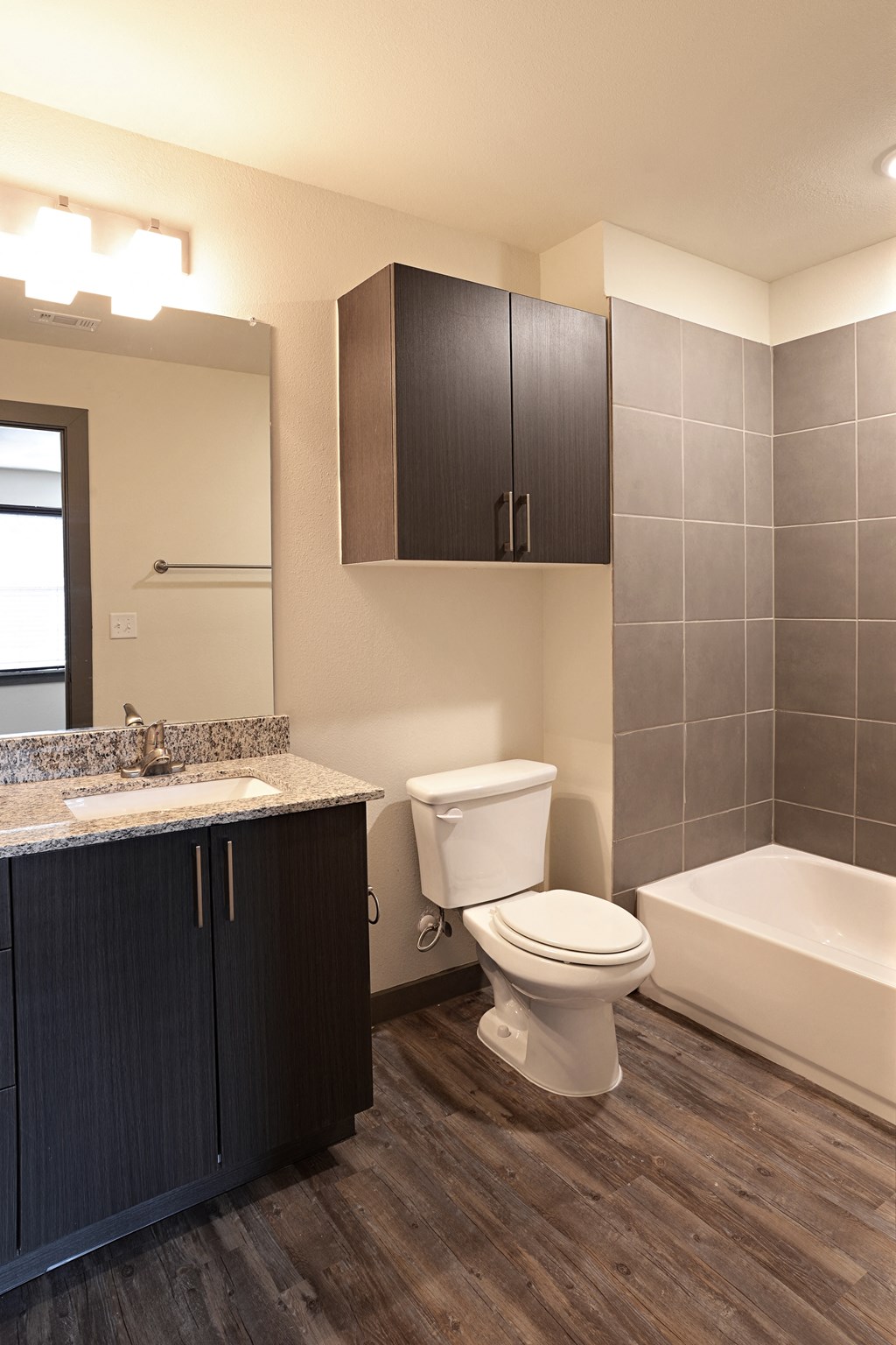 a bathroom with a toilet and a sink and a bath tub