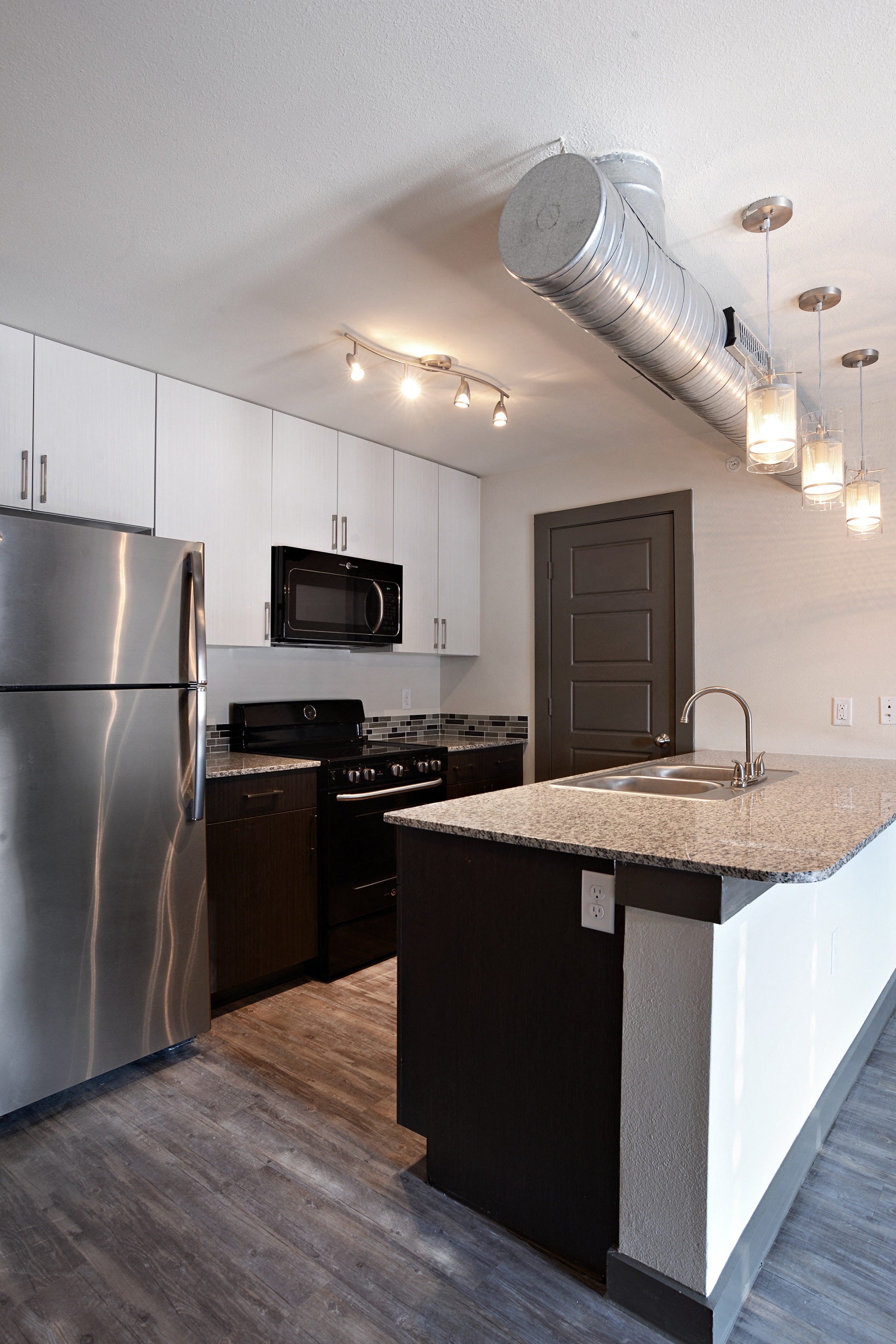 a kitchen with stainless steel appliances and a granite counter top