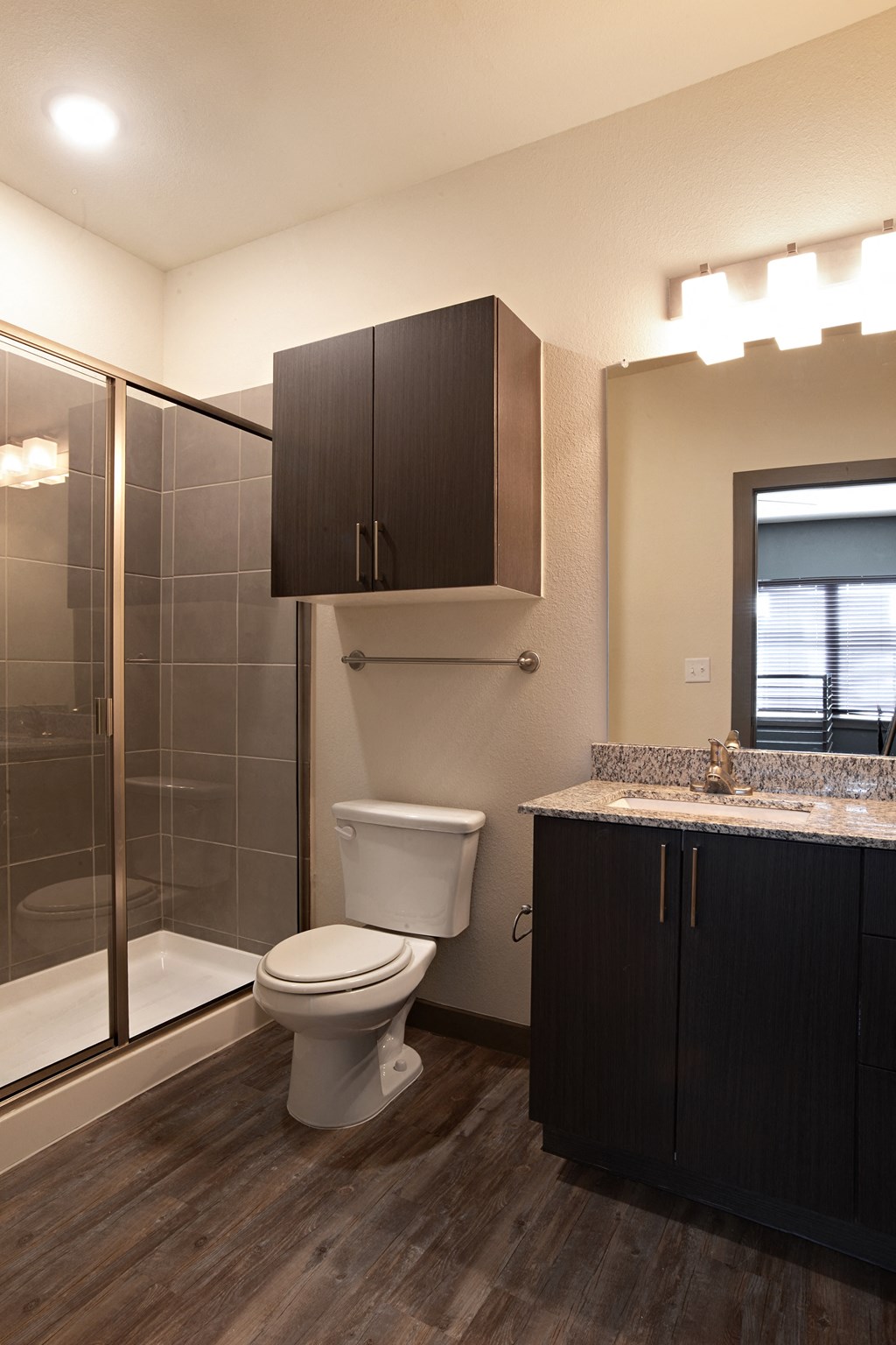 a bathroom with a toilet and a shower and a sink