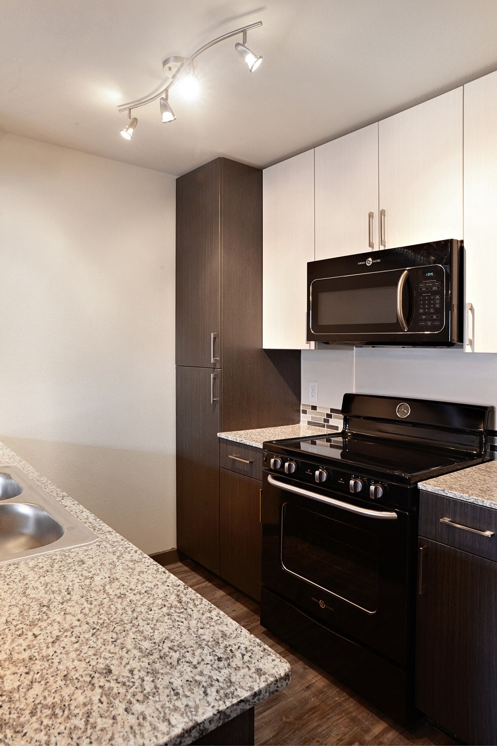a kitchen with black appliances and granite counter tops