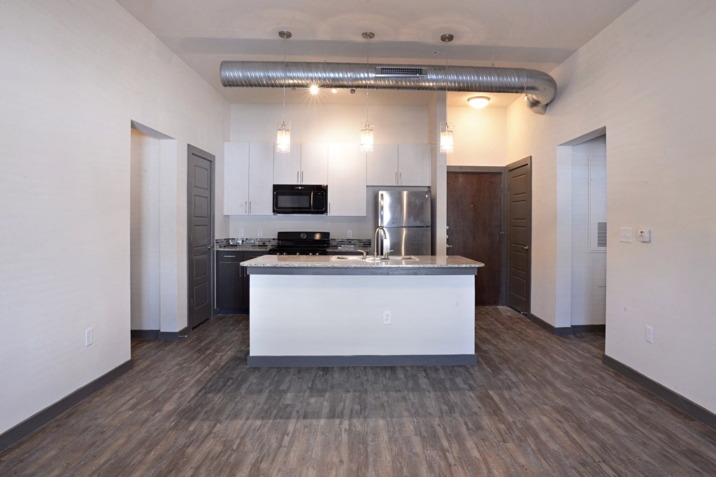 a kitchen and living room with a white counter top