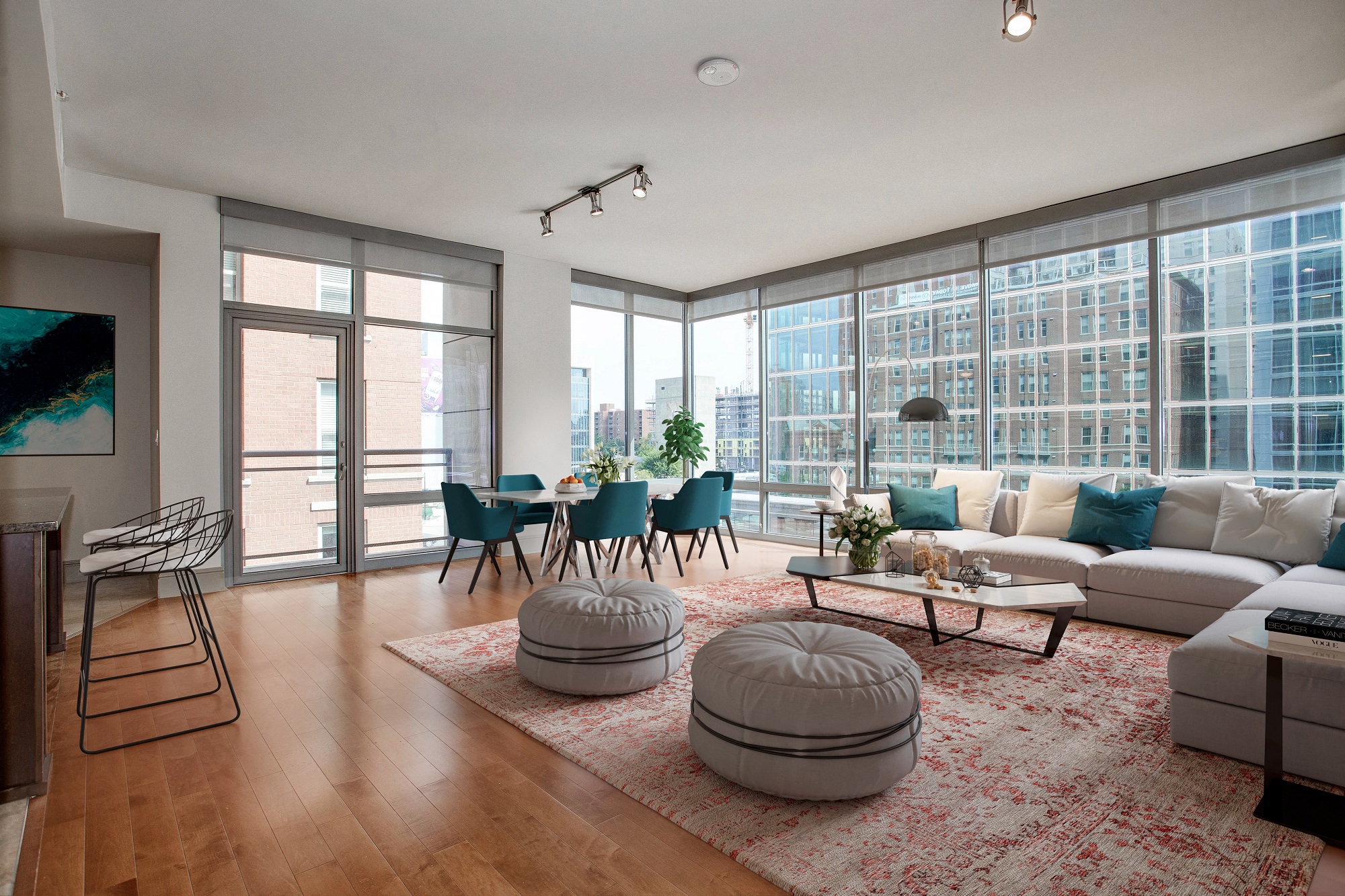 a living room with a couch and a table in front of windows