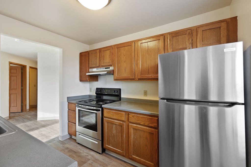 a kitchen with stainless steel appliances and wooden cabinets