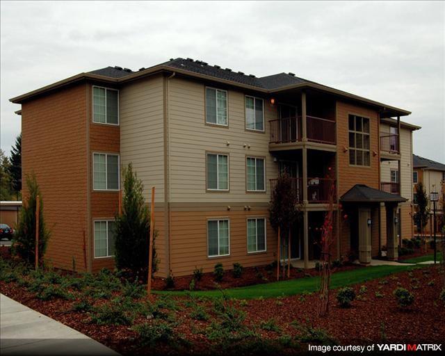 A multi-story residential building with a balcony on the second floor.