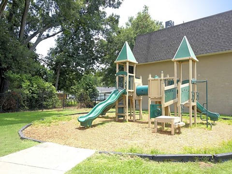 a playground with a jungle gym and slides