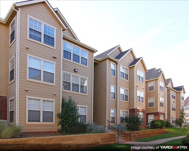 a row of apartment buildings on a city street