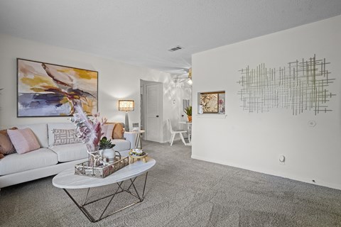 a living room with a white couch and a table