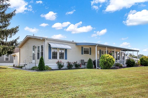 A house with a white fence and a small porch.